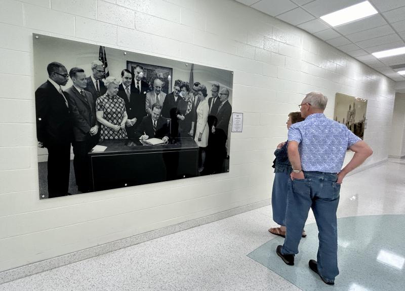 History wall photos include this circa-1970s signing by Gov. Russell W. Peterson of Senate Bill 418, which amended salary schedules for school employees. Frederick D. Thomas is pictured left with legislative and education officials.